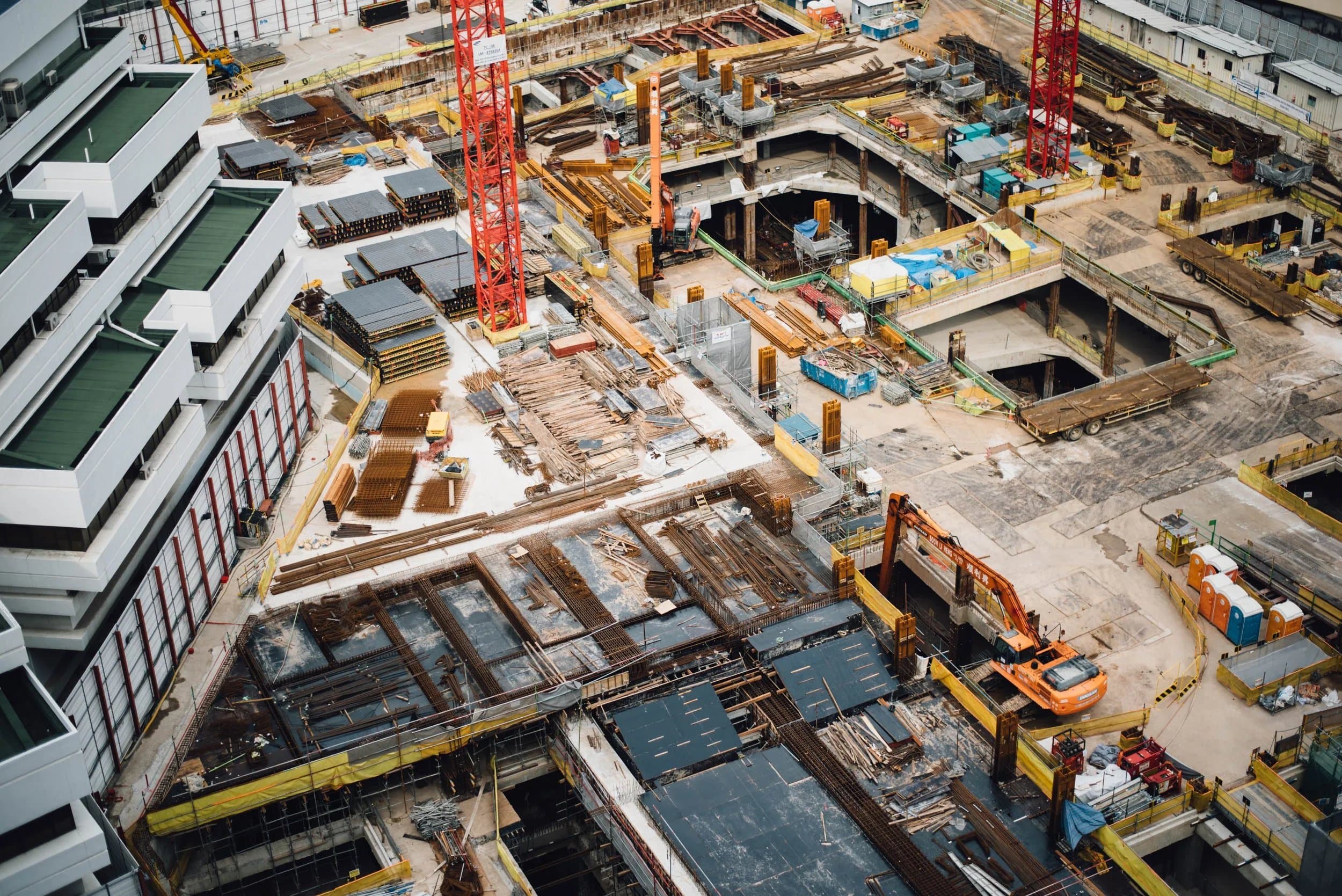 Aerial view of a busy construction site with cranes