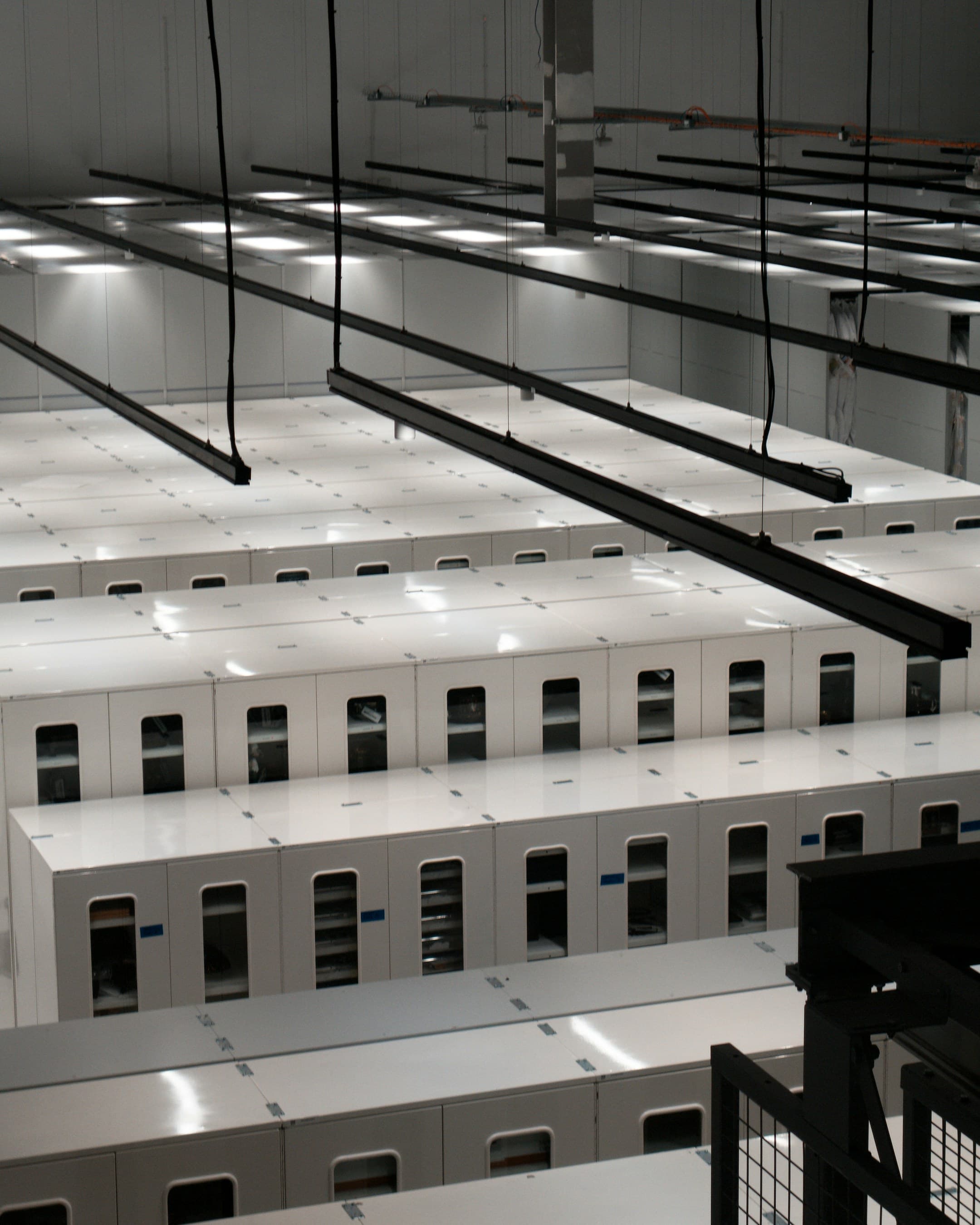 Modern data centre with rows of white server cabinets